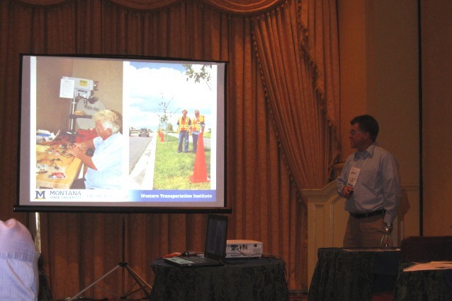 Doug Galarus presents the aSE Smart Drums from a technical perspective.  The slide shows Larry Hayden and student Tyler Paine working on development and testing in the early stages of the project.