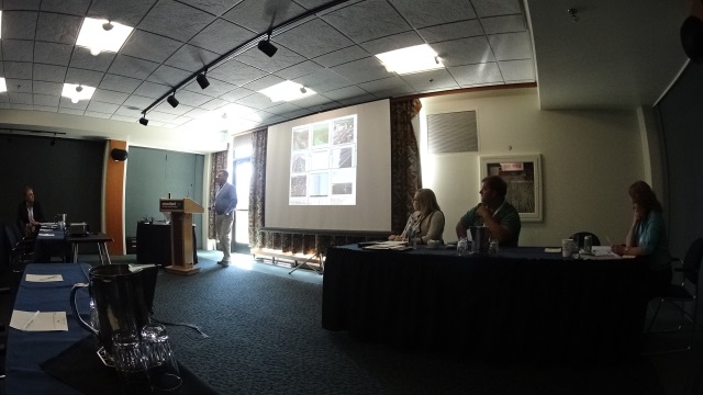 Doug Galarus discusses traveler information data quality. Leann Koon is seated to the right.