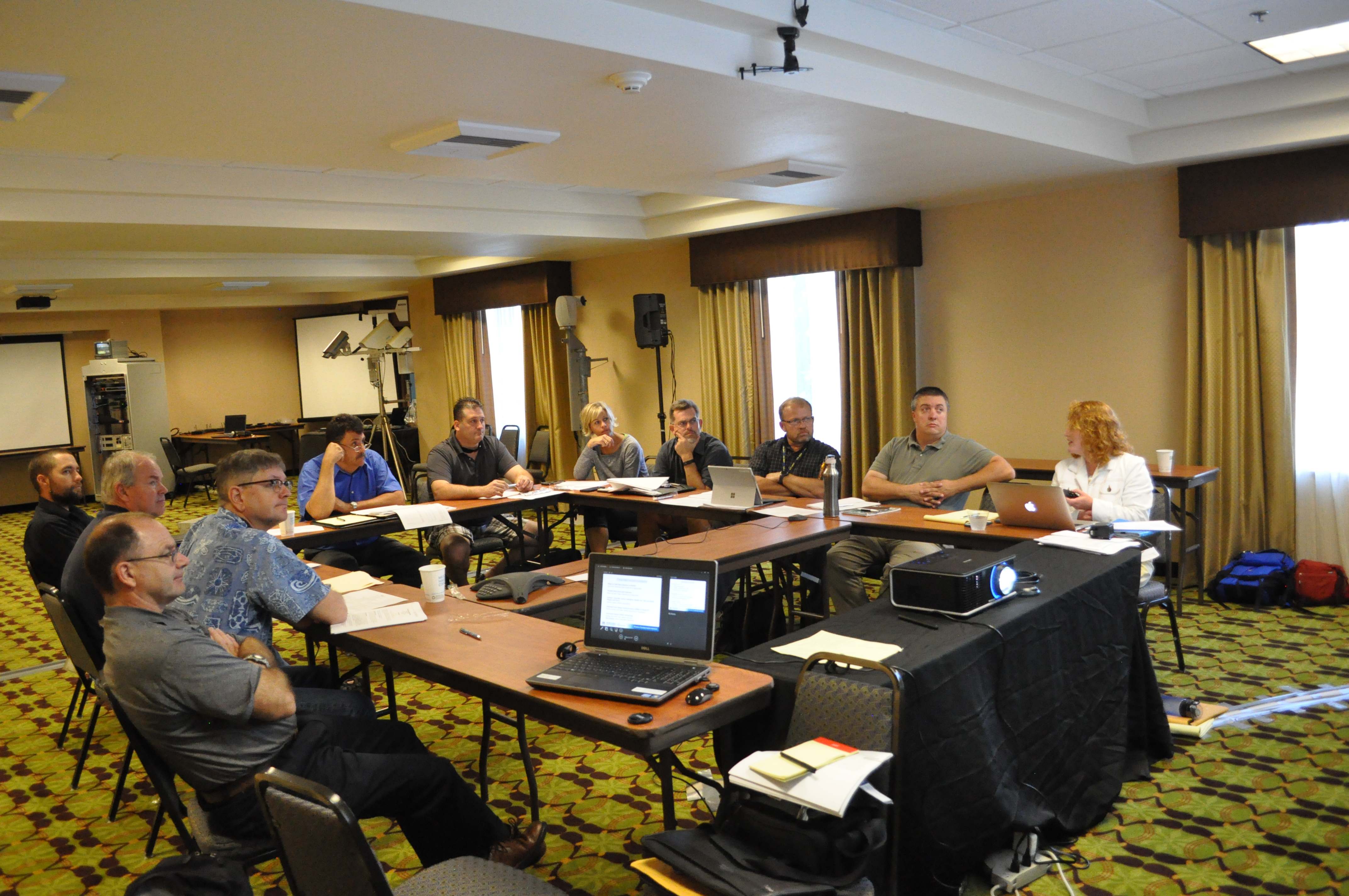 The Western States Rural Transportation Consortium Steering Committee’s (WSRTC) annual meeting on June 21st, 2016, in Yreka, California. A group of people seated at rectangular tables arranged in a U shape, projector.