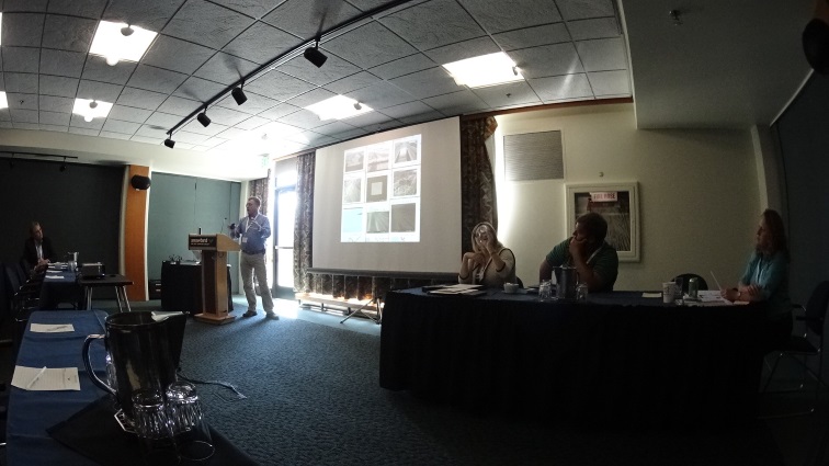 Doug Galarus discusses traveler information data quality. Leann Koon is seated to the right.