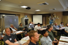 Sean Campbell from Caltrans DRISI raises his hand to ask a speaker a question during a technical presentation at the 2016 Western States Rural Transportation Technology Implementers Forum.