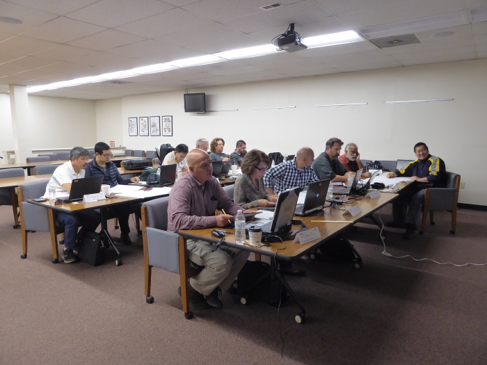 Students listen to instructor Phil Isaak while following along in their course materials.