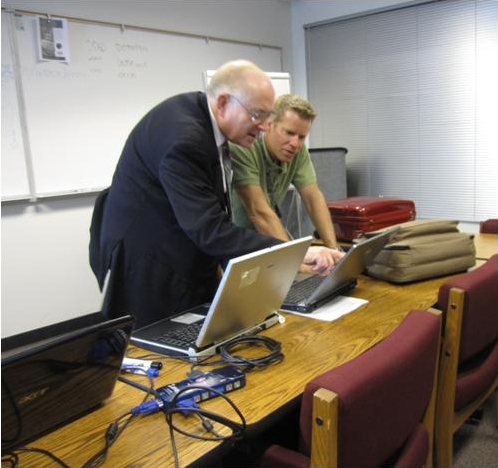 Dean Campbell works with the instructor to run calculations and monitor the performance of one of District 3’s radios.