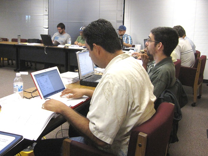Luis Torres works through one of the spreadsheet exercises during the design section of the course.