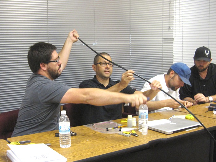 Keith Koeppen and Jeff Worthington work together on the cable end preparation lab exercise.