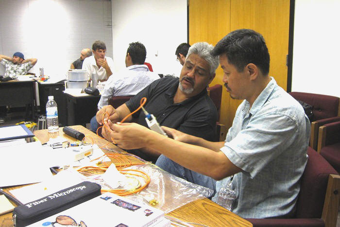 Loss testing during hands-on lab exercises.  Richard Montoya (left), Dave Le (right). (Mastering Fiber Optic Network Design and Installation, 2012)
