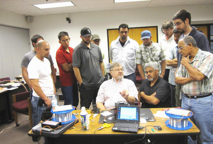 The class gathers around the instructor to watch the fusion splice demonstration.