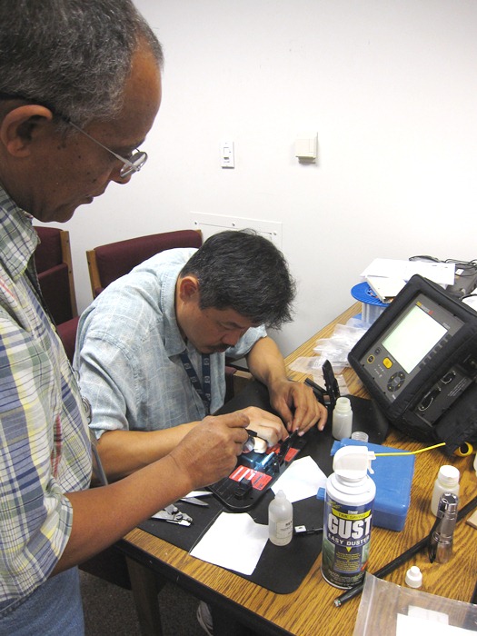 Dave Le completes a mechanical splice as Berhanu Zergaw observes.