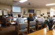 Link, thumbnail, students seated at tables listening to instructor.