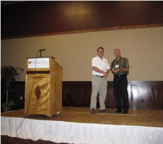 Doug Galarus accepts the award from Steve Albert, Rural SIG Chair and Director of the Western Transportation Institute. Doug Galarus accepts the award from Steve Albert, Rural SIG Chair and Director of the Western Transportation Institute.