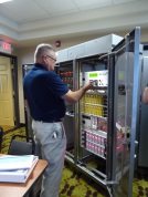 Participant David Arias (Caltrans District 6) checks out the functionality of a newer Caltrans LX controller cabinet, on display as part of Herasmo Iniguez's presentation in 2016.