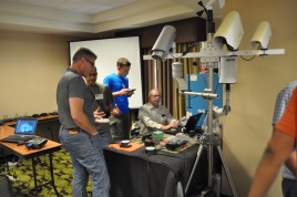 During a networking session at the 2016 Forum, speakers Jeff Worthington and Mike Beyer from Caltrans District 2 discuss and demonstrate topics from their presentation including a redesigned RWIS RPU, and in-pavement and out-of-pavement sensors and their associated software. During a networking session at the 2016 Forum, speakers Jeff Worthington and Mike Beyer from Caltrans District 2 discuss and demonstrate topics from their presentation including a redesigned RWIS RPU, and in-pavement and out-of-pavement sensors and their associated software.