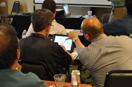 Chris Strong (City of Gresham, OR) on the left and John Castro (Caltrans Headquarters Operations) on the right work together using WSDOT’s Highway Activities Tracking System (HATS) iPad application while Joe Schmit conducts his live demonstration of the system during the 2016 Forum.