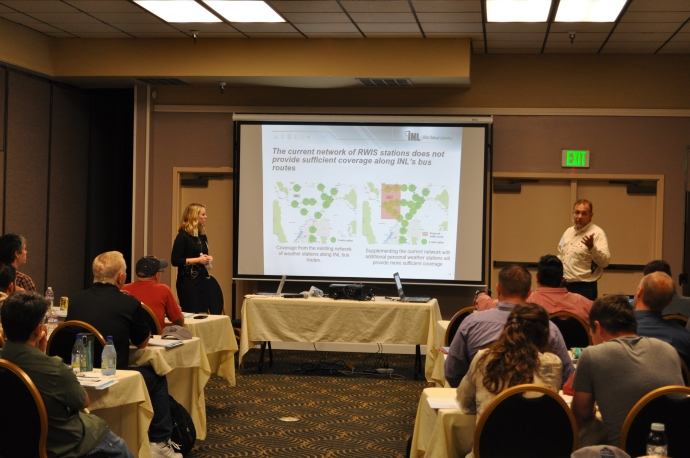 Ira Pray (right) and Sarah Lightbody (left) compare the current RWIS network coverage with the potential coverage area if additional personal weather stations supplemented the existing network.