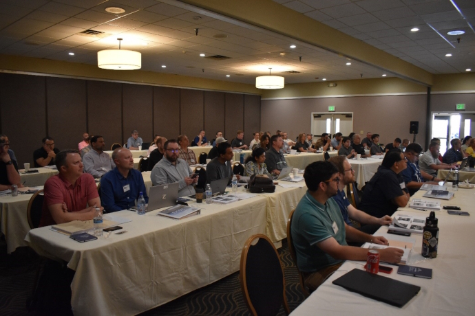 Audience at 2023 Western States Forum A group of people sitting at tables listening to a speaker.