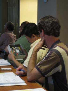 WSF participants look at system components during a technical presentation.