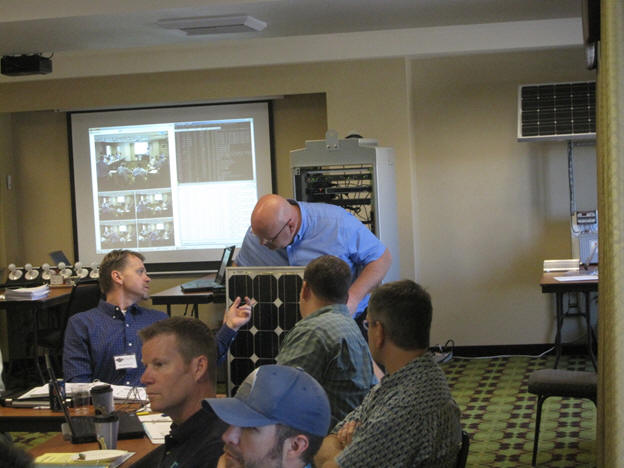 Jon Dickinson showing a solar panel to the group.