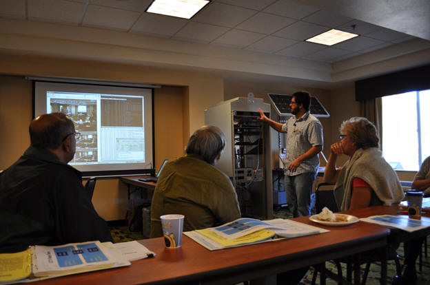 Keith Koeppen demonstrating the information relay system he helped develop.