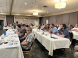 A seated audience watching a presenter, thumbnail, link
